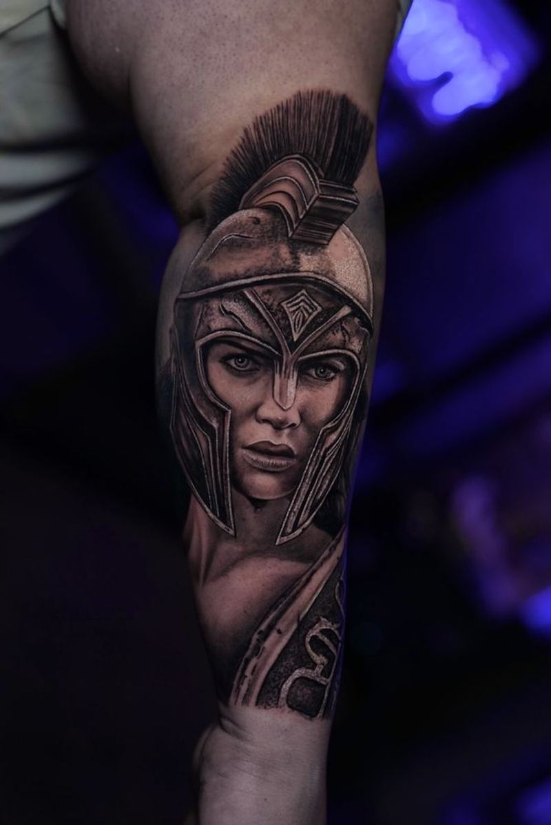 Black-and-gray realism Athena tattoo on an arm